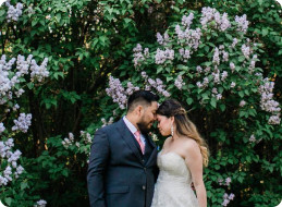a couple looking in front of a bush
